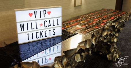 Photograph: Bride and groom holding hands on a grassy hill
